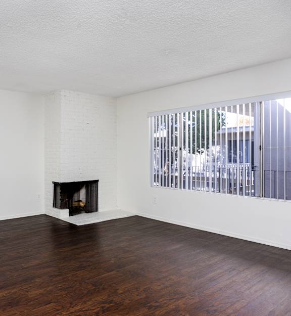 a bedroom with a bed and a living room with a couch and a fireplace