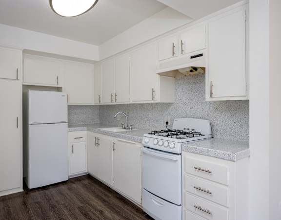 a kitchen with white appliances and white cabinets