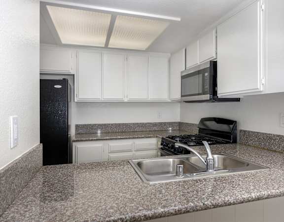 a kitchen with granite counter tops and a sink