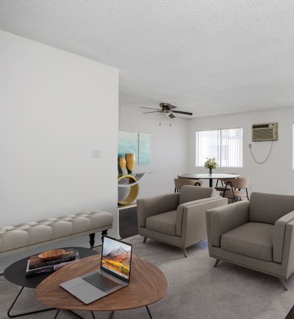 an empty living room with hard wood floors and a ceiling fan