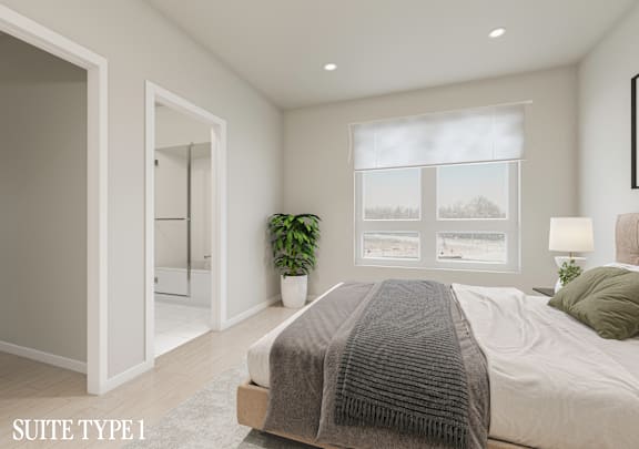 A bedroom with a bed, a potted plant, and pictures on the wall.