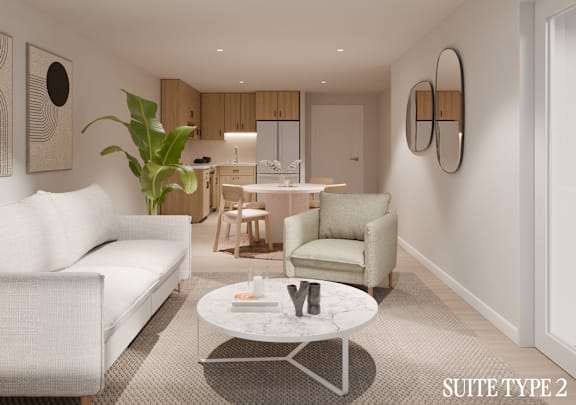 A modern living room with a white sofa, a coffee table, and a dining area in the background.