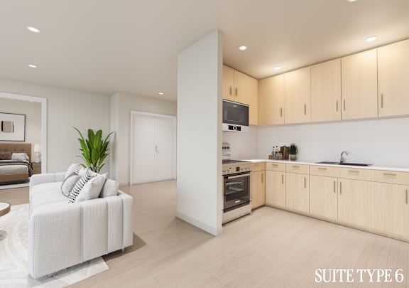 A modern kitchen with wooden cabinets and a white sofa.