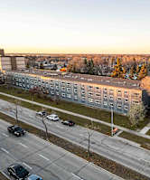 A parking lot with cars and trees in the background.