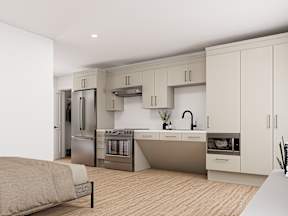 A modern kitchen with a bed in the foreground.