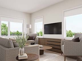 A modern living room with a grey sofa, a wooden coffee table, and a flat screen TV.