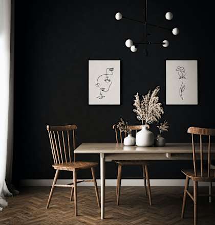 a dining room with a table and chairs and a black wall