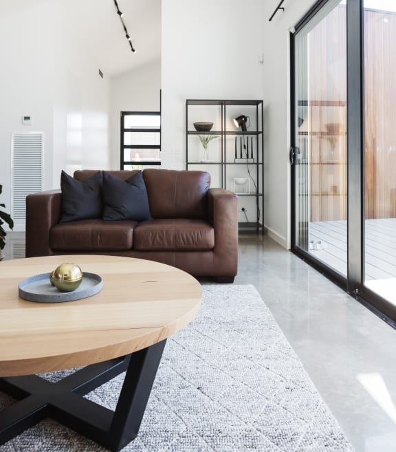 a living room with a leather couch and a coffee table