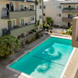a swimming pool in front of an apartment building