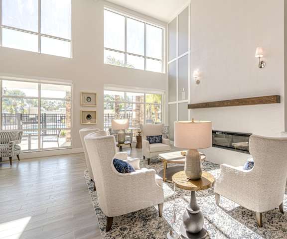 A living room with a fireplace and a large window. at Sandpiper Glen 62+ Apartments, Orlando, FL