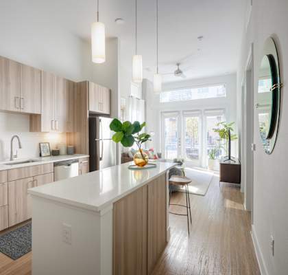 A modern kitchen with wooden cabinets and a white island.