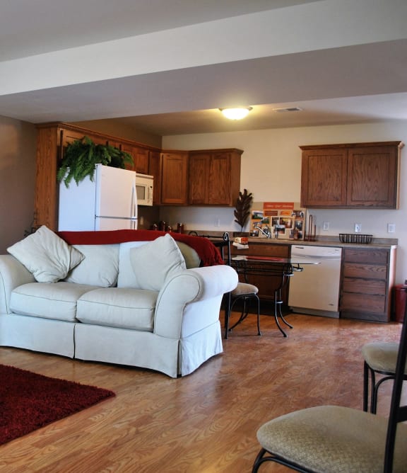 a living room with a fireplace and a table with potted plants