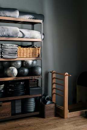 A shelf with baskets and bags on it.