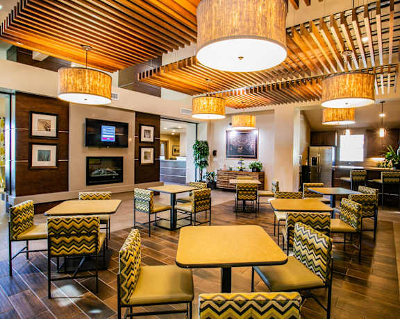 a dining room with tables and chairs and a fireplace