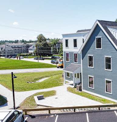 a gray house with a gray roof in a parking lot