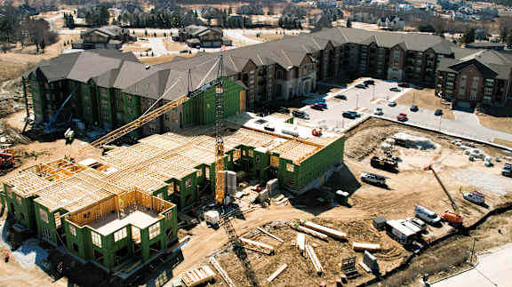 A construction site with a green building under construction.