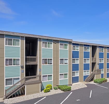 A parking lot in front of a row of apartments in Renton, WA at Peak 88.