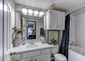 Thumbnail 11 of 54 - A bathroom with a white tub, sink, and toilet.
