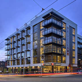 A Clarendon hotel building with a street in front of it.