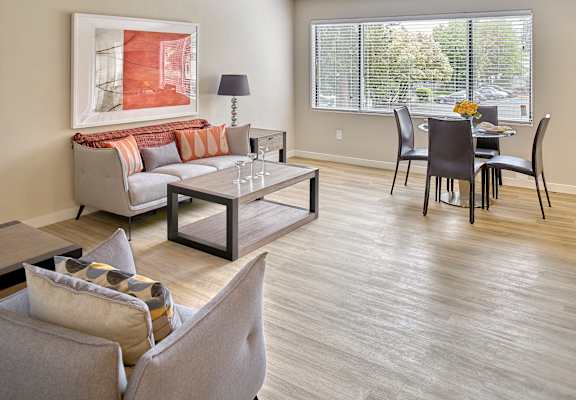 a living and dining room area with a couch table and chairs and a large window  at 3030 Lake City, Seattle, Washington