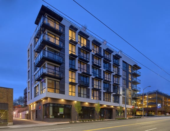 a rendering of a large building with many windows and a street in front of it