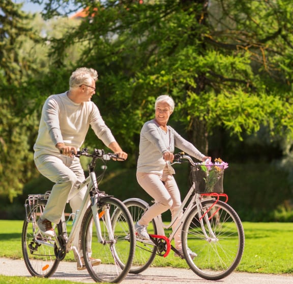 West St. Paul, MN Covington Court |a man and a woman riding bikes in a park