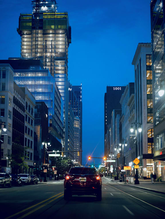 A group of tall buildings with a blue sky in the background.
