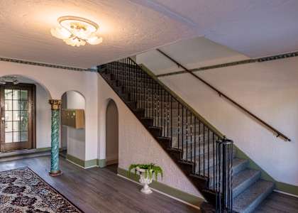 a staircase in a house with a wood floor and a rug