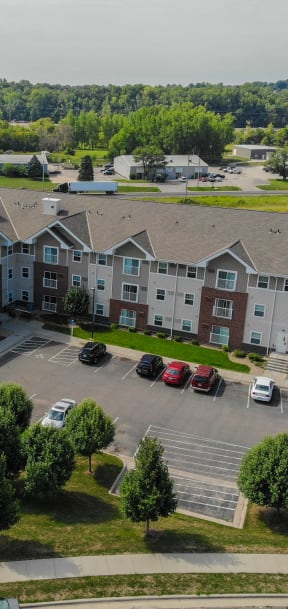 an aerial view of an apartment building in a parking lot