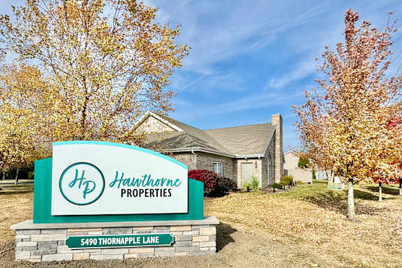 the sign at the entrance to a city with flowers at Hawthorne Properties in Lafayette, IN 47905