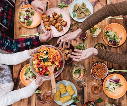 a group of people sitting around a table eating food at Monterey Ranch, Austin, TX, 78749