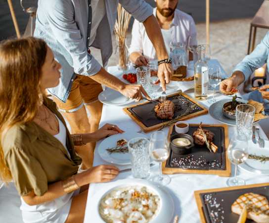 a group of people eating food at a table