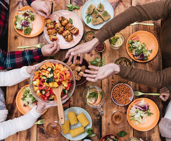a group of people sitting around a table eating food at Links at High Resort, New Mexico