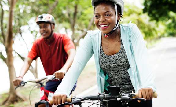 a woman and a man riding bikes at Bigelow Commons, Enfield, 06082