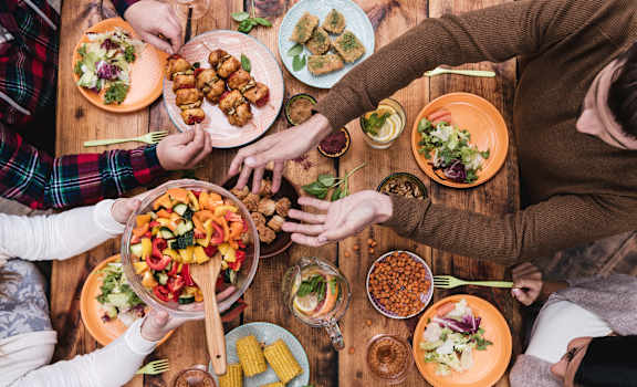 a group of people sitting around a table eating food at Monterey Ranch, Austin, TX, 78749