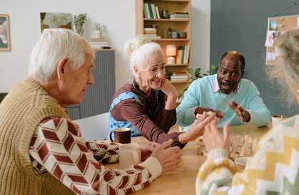 A group of elderly people playing a board game together.
