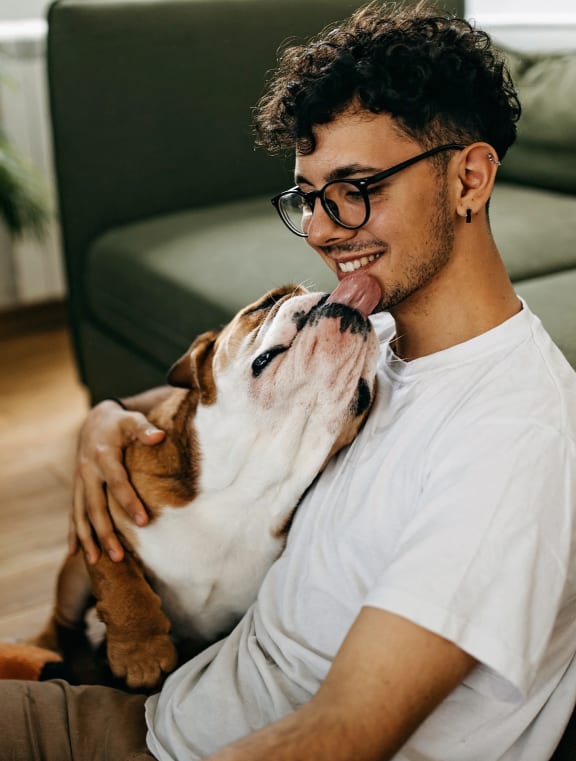 a dog and his owner in a living room at Earle Manor Apartments, Wheaton, Maryland