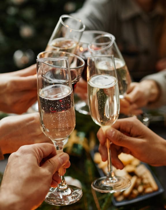 a group of people holding champagne glasses at a table at Cityscape, St Louis Park, 55416