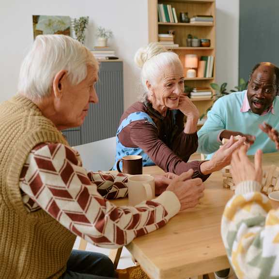 A group of elderly people playing a board game together.