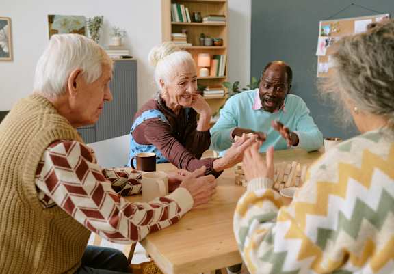 A group of elderly people playing a board game together.