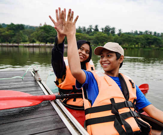 a man and a woman in a canoe on a lake at Estates at Heathbrook, Ocala, Florida