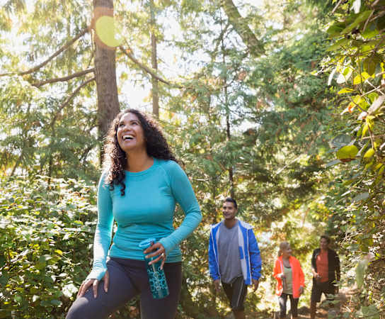 a group of people walking through a forest at Estate at Woodmen Ridge, Colorado Springs
