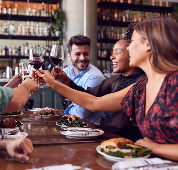 people making a toast at a restaurant table at Northland at the Arboretum, Austin, 78759