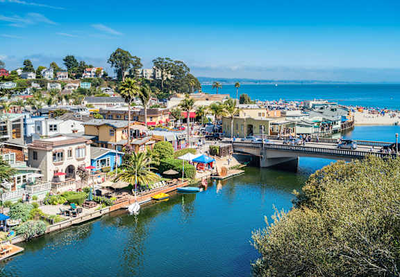 A beautiful coastal town with a bridge over a calm river.