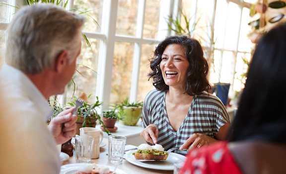 a group of people sitting around a table eating food at Lakes at Suntree, Melbourne, Florida