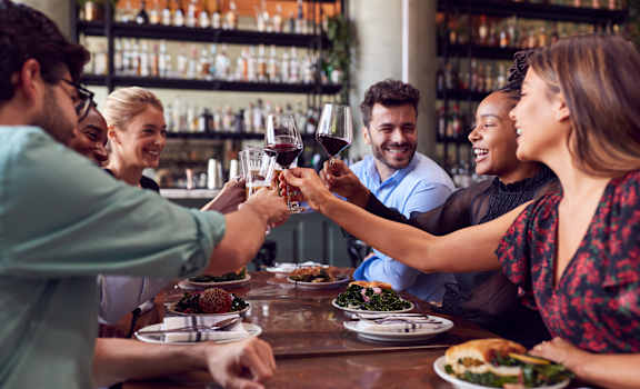 people making a toast at a restaurant table at Glenn Perimeter, Atlanta, Georgia