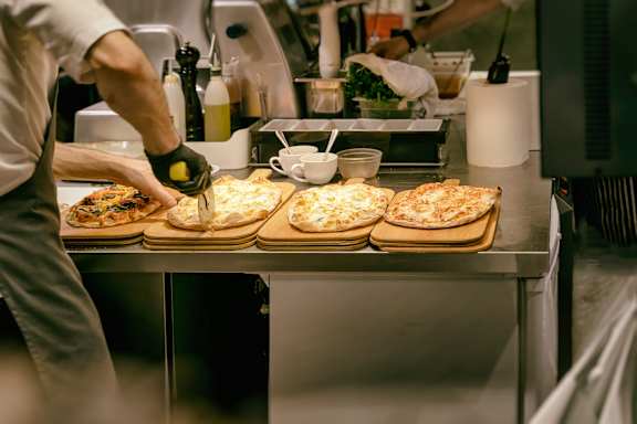 People are eating pizza and drinking beer at a table at Skye at Belltown Apartments, Washington