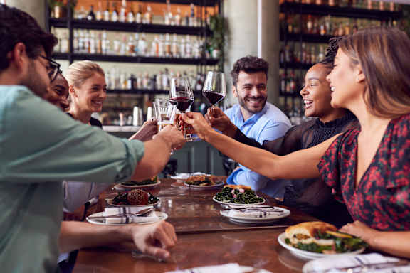 people making a toast at a restaurant table