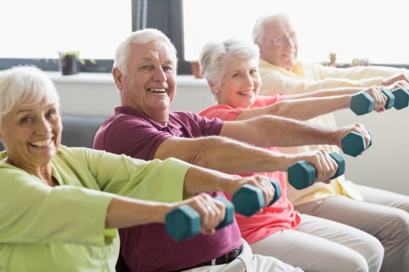 A group of residents exercising with dumbbells