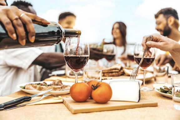a group of people sitting around a table drinking wine at Apex Mission Valley, California, 92108